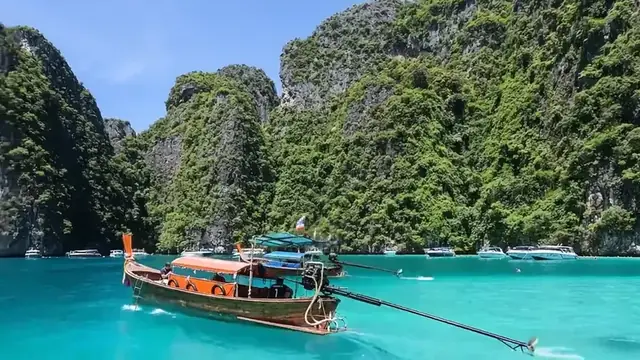 A longtail boat on emerald water in Krabi